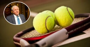 Close-up shot of a tennis racket lying on the ground with two tennis balls resting on it. In the upper left corner, an inset image features an elderly man with white hair, wearing a blue tie and dark suit, speaking animatedly.