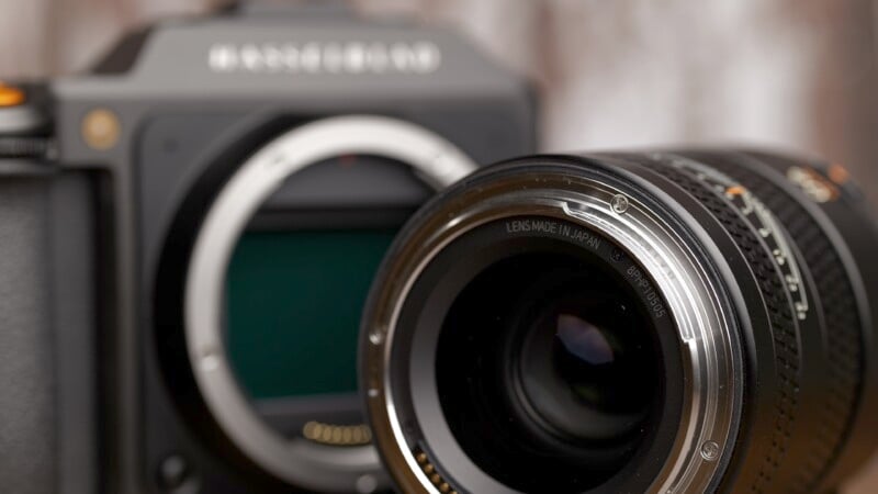 Close-up of a professional camera with a detailed view of the lens and brand markings, emphasizing its quality and intricate design.