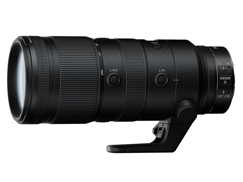 A black NIKKOR Z 70-200mm f/2.8 lens with zoom and focus rings, various control switches, and a tripod collar, designed for use with Nikon cameras. The lens has an adjustable focal length and a stabilizing mount at the bottom for attaching to tripods.