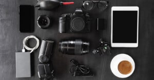 A mix of photography equipment laid out on a black table.